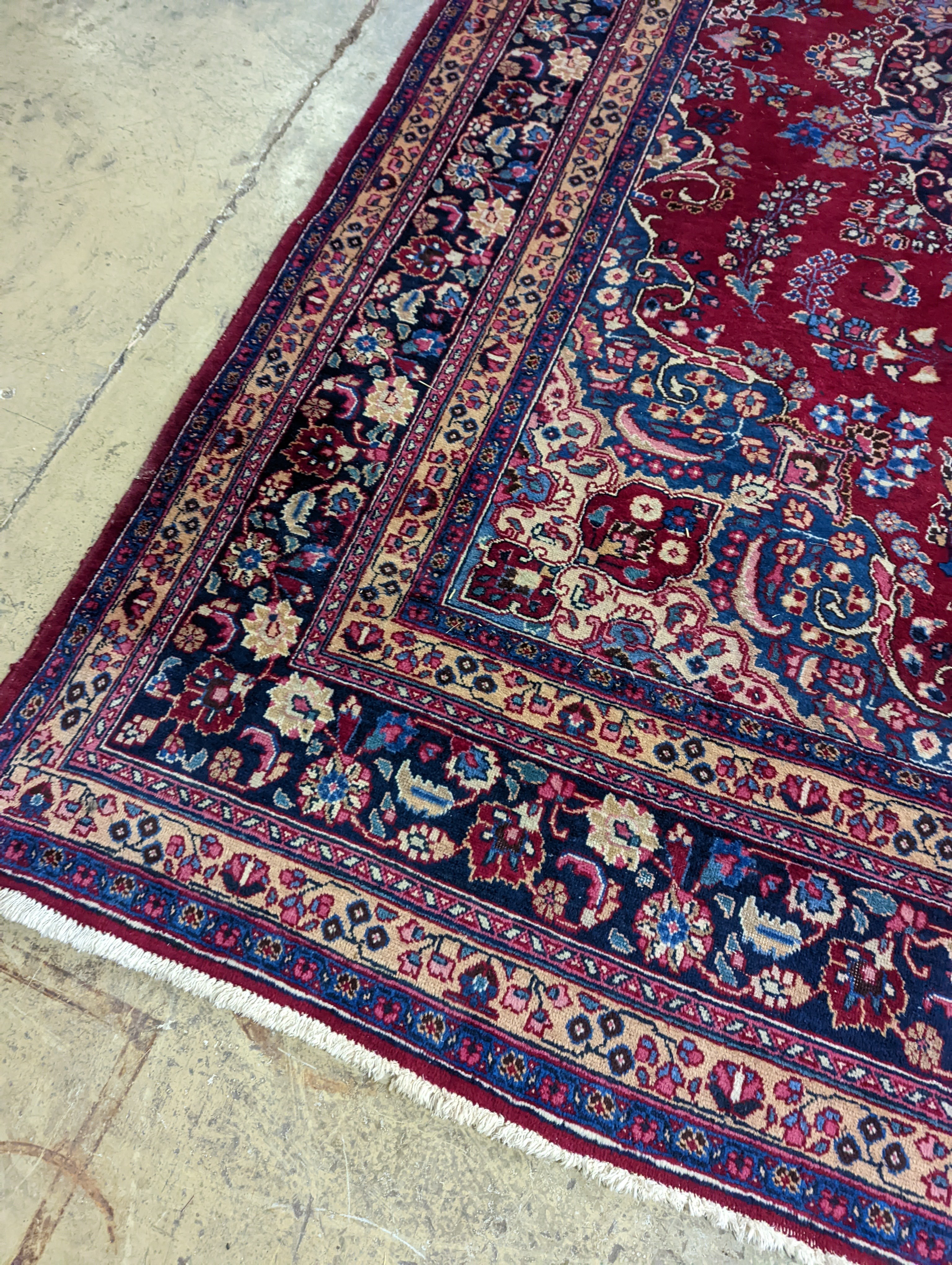 A Tabriz burgundy ground carpet, 350 x 250cm